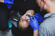 Orthodontic treatment of teeth. Close-up of female teeth with braces. The doctor installs metal braces on the patient's teeth. Oral care. Selective focus