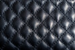 Texture of black leather. Black leather stitched with parallel lines. Rhombus textured leather