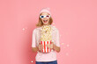 woman in 3d-glasses holding bucket of popcorn and jumping