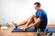 Man with ankle pain after doing indoor sports exercises