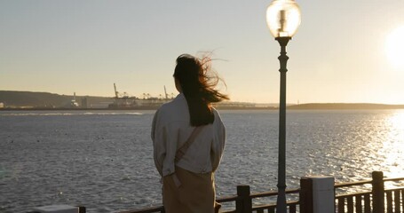 Wall Mural - Woman look at the sunset sea view in Tamsui fisherman Wharf