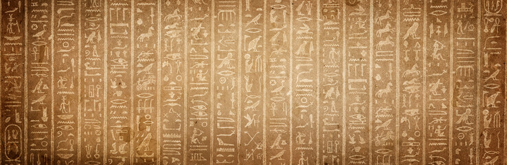 Old Egyptian hieroglyphs on an ancient background. Wide historical and culture background. Ancient Egyptian hieroglyphs as a symbol of the history of the Earth.