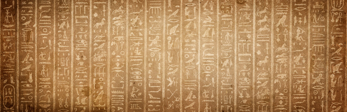 Wall Mural - Old Egyptian hieroglyphs on an ancient background. Wide historical and culture background. Ancient Egyptian hieroglyphs as a symbol of the history of the Earth.
