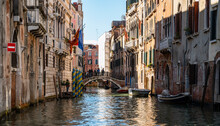 Boats Parked On A Quiet Canal In Venice