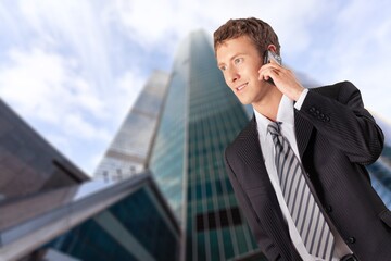 Cheerful young businessman hold a smartphone