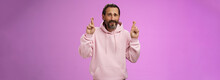 Nervous Unsure Hopeful Handsome Bearded 40s Man In Pink Stylish Hoodie Cringing Worried Cross Figers Good Luck Make Wish Hope Not Gonna Lose Job Supplicating Praying Dream Come True