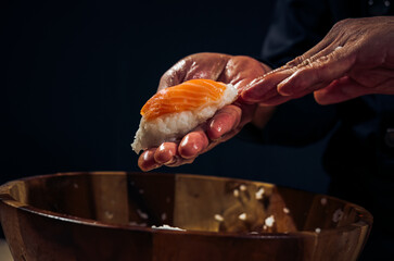 Wall Mural - Japanese chef making rice nigiri sushi with tuna, salmon, shrimp,traditional Japanese food ,Dark Tone