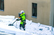 Worker cleans snow on the roof