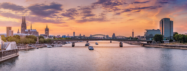 panoramic view of the city of koln, the rhine river, bridges and various barges and ships during maj