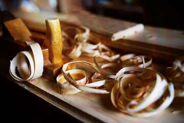 Hand planer with wooden sawdust. On a wooden background. High quality photo