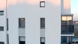 © Media Whale Stock - Top view of modern residential building with windows. Stock footage. Vertical panning of residential building with windows. Reflection of sky in windows of residential building