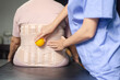 © gballgiggs - Physiotherapist massage back patient women with ball at hospital,Physical therapy concept