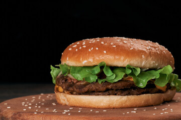 Wall Mural - close-up. delicious hamburger on a wooden board.