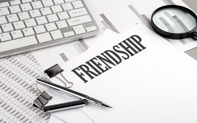 FRIENDSHIP text on paper with chart and keyboard, business concept