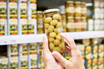 Wall Mural - Canned olives in hands buyer in shop