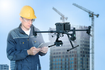 Aufkleber - Engineer with digital tablet controls drone on a construction site	