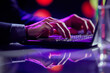 © Lustre Art Group  - Cropped image of male hands of business man typing on laptop keyboard at evening time. Cool colored neon hue lights in office space.