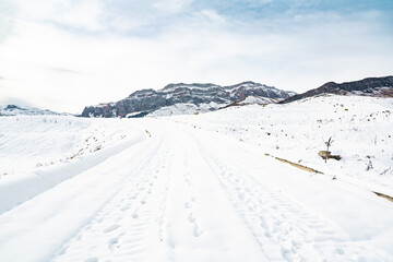 Wall Mural - Snow capped mountains with ski tracks