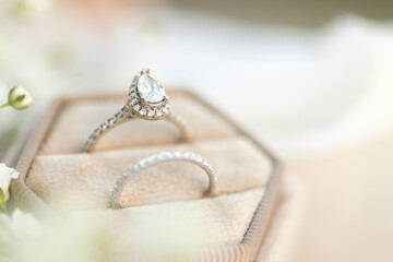 Bride diamond wedding ring and engagement band in a cream velvet ring box