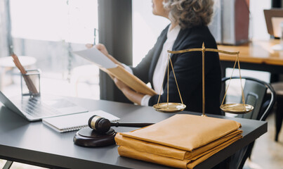 Wall Mural - Business and lawyers discussing contract papers with brass scale on desk in office. Law, legal services, advice, justice and law concept picture with film grain effect