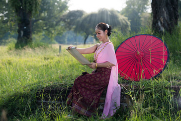 portrait Asian woman  in Thai traditional with umbrella in Ayutthaya, Thailand.