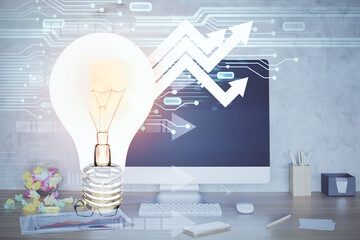 Poster - Computer on desktop in office with bulb icon hologram. Double exposure. Concept of idea.