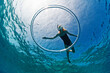 Woman snorkeling and watching the ring bubble rising to the surface