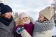 © supersomik - Grandmother, mother and daughter are walking in the winter city park on Christmas and New Year holidays. Parent and little child having fun outdoors