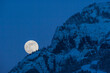 © Designpics - Full Moon rising in a blue, night sky behind a mountain cliff in Lamar Valley in Yellowstone National Park; Wyoming, United States of America