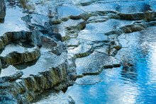 Close-up Of Water From The Hot Spring Flowing Over The Travertine Terraces At Mammoth Hot Springs In Yellowstone Natural Park; Wyoming, United States Of America