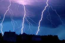 Lightning Strikes Fill The Night Sky Over A Farm And Barn Rooftop, Near Walton, Nebraska, USA; Walton, Nebraska, United States Of America