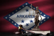 Arkansas US state flag with statue of lady justice, constitution and judge hammer on black drapery. Concept of judgement and punishment