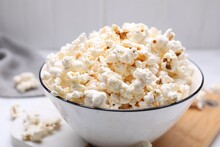Bowl Of Tasty Popcorn On White Table, Closeup