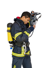 Poster - Young smiling African-American fireman in uniform and with air breathing apparatus takes off protective mask from his head. Side view, isolated on white background