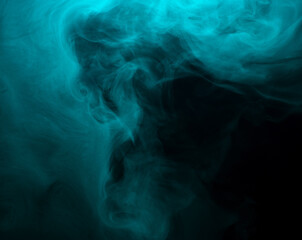 Wall Mural - Abstract background of chaotically mixing clouds of turquoise smoke on a background of darkness