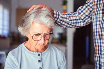 Senior man comforting his depressed illness wife, unhappy elderly woman at home need medical help. Ourmindsmatter