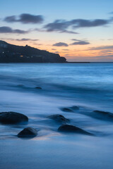 Canvas Print - Stunning landscape image of Sennen Cove in Cornwall during sunset with dramatic sky and long exposure sea motion