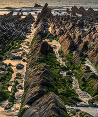 Wall Mural - Beautiful sunset landscape image of Welcome Mouth Beach in Devon England with beautiful rock formations