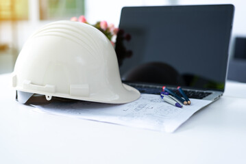 Wall Mural - Safety helmet and computer of drawing engineer