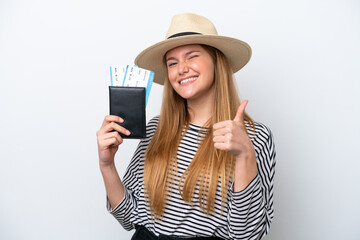 Wall Mural - Young caucasian woman isolated on white background in vacation holding a passport and plane with thumb up
