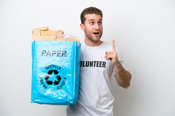 Wall Mural - Young caucasian man holding a recycling bag full of paper to recycle isolated on white background thinking an idea pointing the finger up