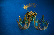 Three crowns of the three wise men with star over blue background. For Reyes Magos day and Happy Epiphany day.