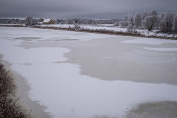 frozen snow and ice covered river Lielupe near Jelgava town in Latvia. Beautiful winter morning