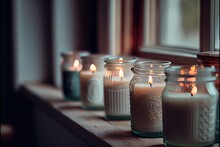  A Row Of Candles Sitting On A Window Sill Next To A Window Sill With A Window Sill In The Background.