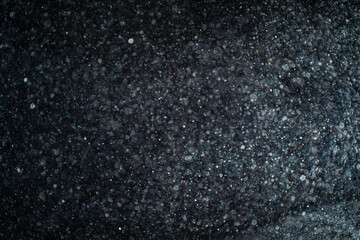 Wall Mural - Abstract real dust particles on black background. Glittering sparkling bokeh overlay design with copy space for text. High quality photo