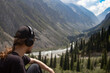 © Chepko Danil - Young man in headphones listening music in nature and at the summer mountain