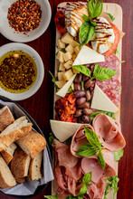 Charcuterie Board. Cheese Board Assortment On Cured And Salted Deli Meats And Cheeses, Pastrami, Salami, Prosciutto Served With Olives And Dried Fruits. Classic Traditional Party Favorite.  