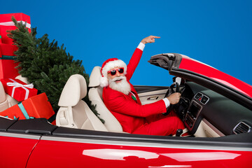 Sticker - Photo of cool excited santa claus helpers wear costumes riding vehicle gifts delivery pointing empty space isolated white color background