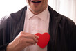 © Erika - man holding a heart. Happy day. Valentine day. Sensual. Smiling. Heart.