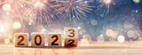 Fototapeta Kawa jest smaczna - 2023 New Year Celebration - Wooden Number Blocks And Fireworks At Blue Eve Night With Abstract Defocused Lights